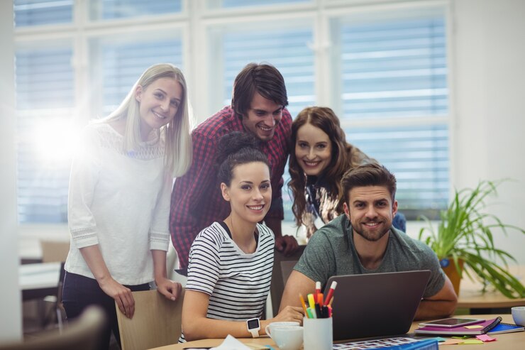 group business executives smiling camera their desk 1170 1997